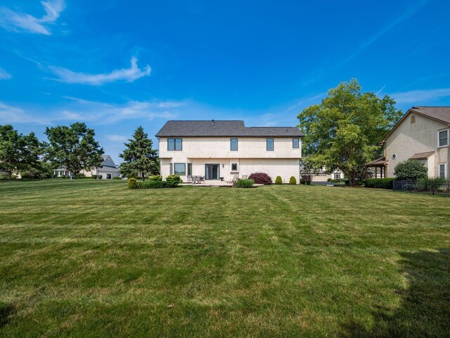 7635 Overland Trl, Delaware, OH 43015 - back of house featuring stucco siding, a yard, and a patio