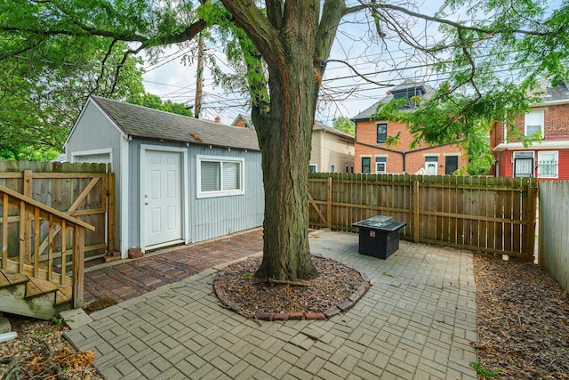 489 Elsmere St, Columbus, OH 43206 - fenced backyard with a patio, an outdoor structure, a fire pit, and a gate