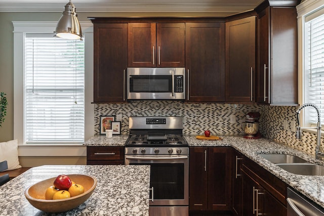 489 Elsmere St, Columbus, OH 43206 - kitchen with stainless steel appliances, tasteful backsplash, dark brown cabinetry, light stone counters, and ornamental molding