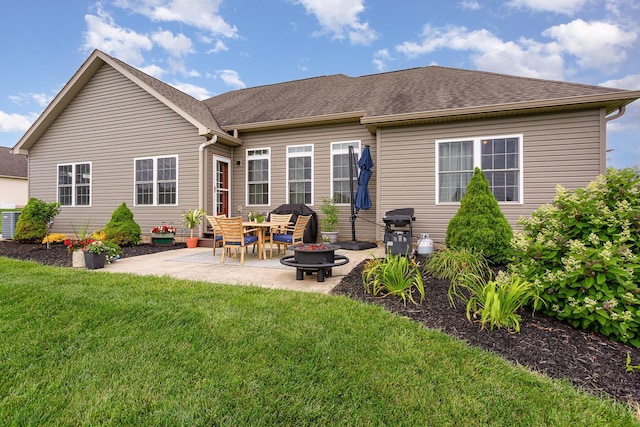 5582 Hayesville Rd, Circleville, OH 43113 - rear view of house with a yard, a patio, a fire pit, and roof with shingles