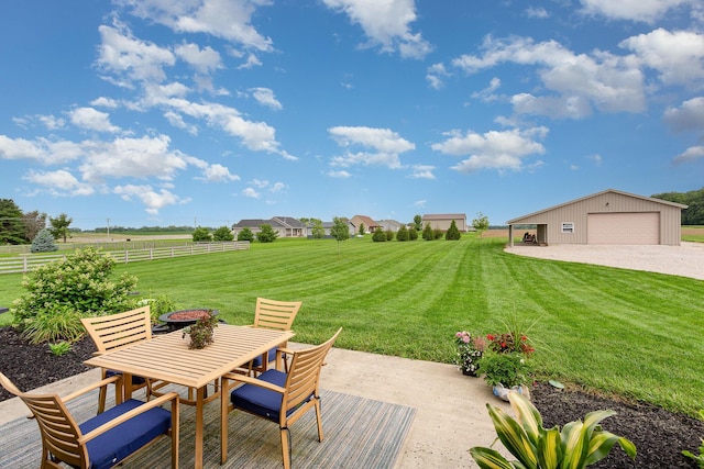 5582 Hayesville Rd, Circleville, OH 43113 - view of patio featuring outdoor dining area, a detached garage, an outdoor structure, and a view of rural / pastoral area