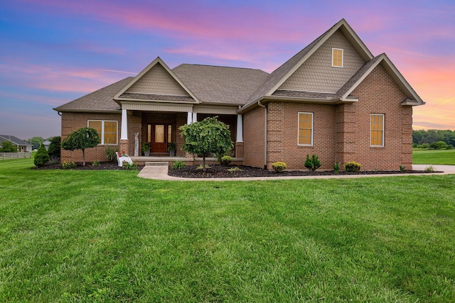 5582 Hayesville Rd, Circleville, OH 43113 - craftsman house with brick siding, a front yard, a shingled roof, and covered porch