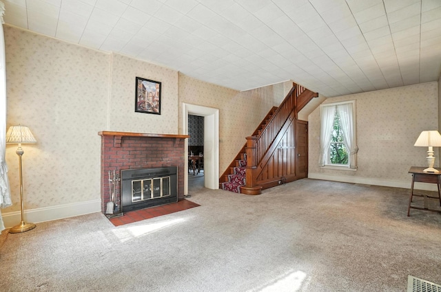 249 W Locust St, Newark, OH 43055 - unfurnished living room featuring stairway, carpet, wallpapered walls, and a brick fireplace