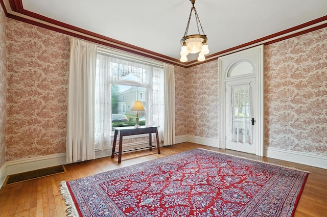 249 W Locust St, Newark, OH 43055 - dining space with wallpapered walls, hardwood / wood-style flooring, a chandelier, and crown molding