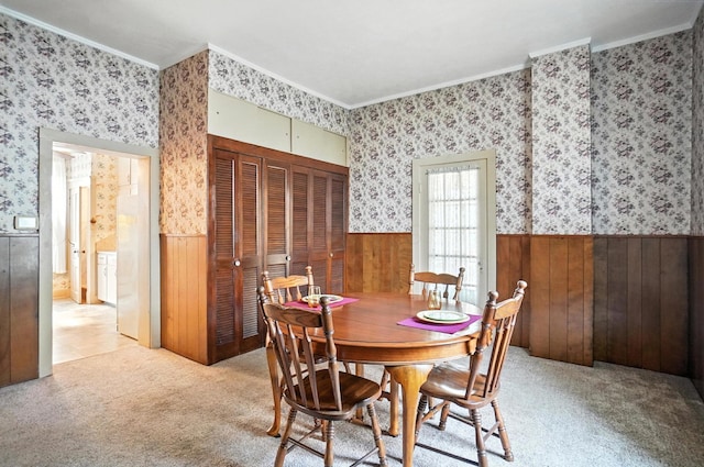 249 W Locust St, Newark, OH 43055 - dining area with crown molding, wainscoting, wooden walls, wallpapered walls, and light carpet