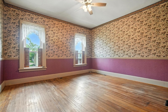 249 W Locust St, Newark, OH 43055 - spare room featuring wallpapered walls, plenty of natural light, a ceiling fan, wood-type flooring, and wainscoting