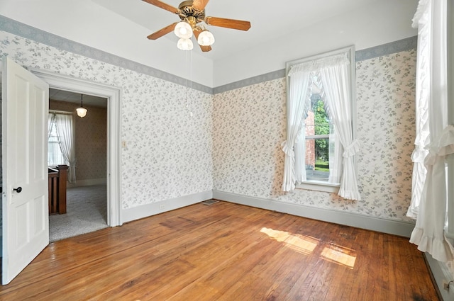 249 W Locust St, Newark, OH 43055 - unfurnished room with wood finished floors, ceiling fan, and wallpapered walls