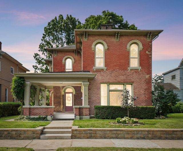 249 W Locust St, Newark, OH 43055 - italianate home featuring brick siding, covered porch, and a front yard