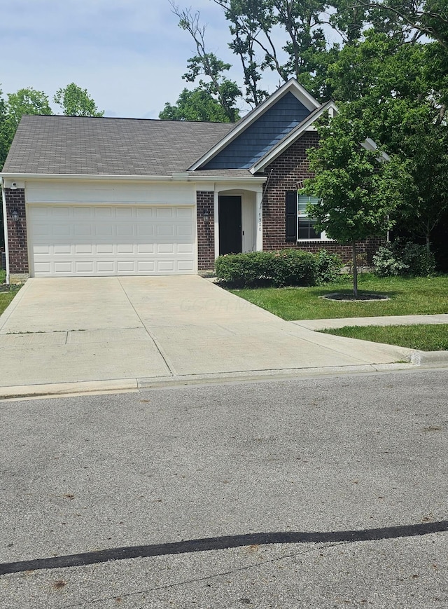 7520 Autumn Joy Ave, Canal Winchester, OH 43110 - view of front of property with brick siding, a garage, driveway, and a front yard