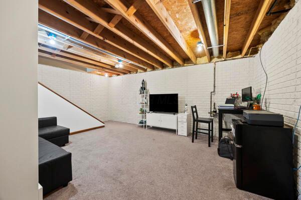 5813 Camhurst Ct, Galloway, OH 43119 - unfinished below grade area with carpet floors and brick wall