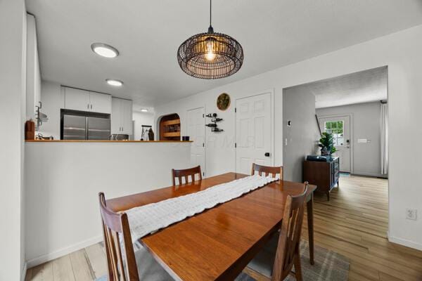 5813 Camhurst Ct, Galloway, OH 43119 - dining space featuring light wood-style flooring and arched walkways