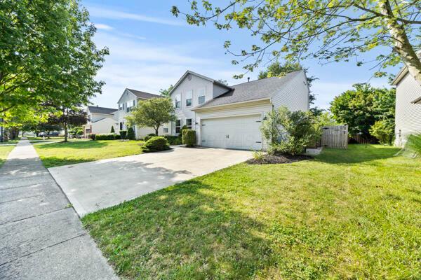5813 Camhurst Ct, Galloway, OH 43119 - view of front of home with concrete driveway, an attached garage, and a front yard