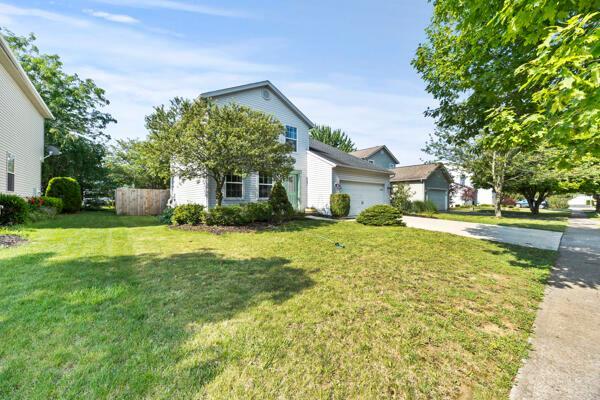 5813 Camhurst Ct, Galloway, OH 43119 - view of property hidden behind natural elements featuring driveway and a garage