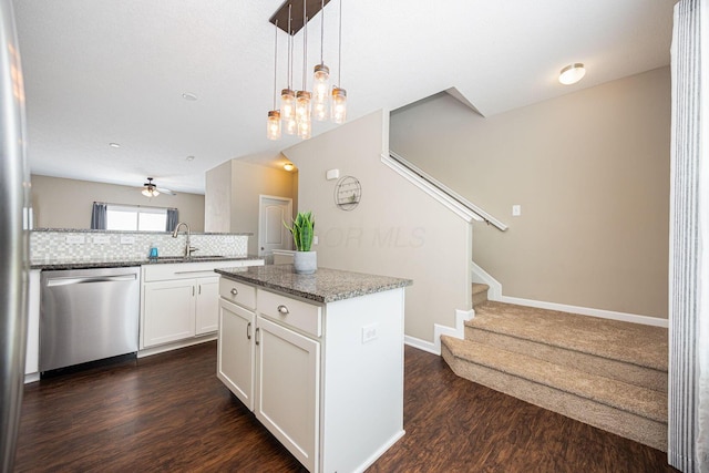 5738 Hayden Run Blvd, Dublin, OH 43016 - kitchen featuring stainless steel dishwasher, dark wood-type flooring, backsplash, a kitchen island, and white cabinets