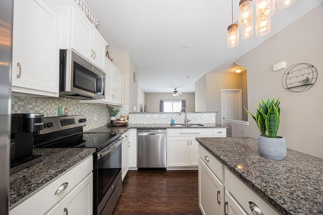 5738 Hayden Run Blvd, Dublin, OH 43016 - kitchen featuring stainless steel appliances, a peninsula, tasteful backsplash, dark wood finished floors, and white cabinets