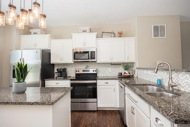 5738 Hayden Run Blvd, Dublin, OH 43016 - kitchen featuring stainless steel appliances, a peninsula, white cabinetry, and dark wood finished floors