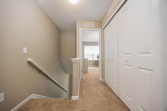 5738 Hayden Run Blvd, Dublin, OH 43016 - corridor with an upstairs landing, light colored carpet, and a textured ceiling