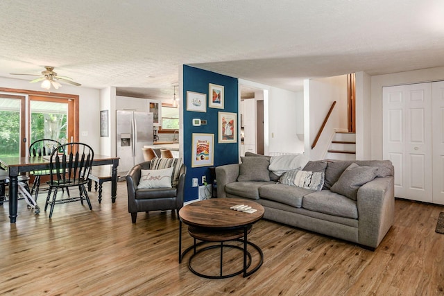 2630 Bella Via Ave, Columbus, OH 43231 - living room featuring ceiling fan, light wood-style flooring, stairway, and a textured ceiling