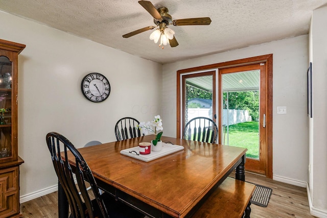2630 Bella Via Ave, Columbus, OH 43231 - dining room featuring light wood-style flooring, a ceiling fan, and a textured ceiling
