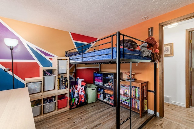 2630 Bella Via Ave, Columbus, OH 43231 - bedroom featuring wood finished floors and a textured ceiling