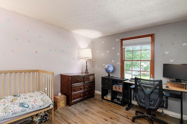 2630 Bella Via Ave, Columbus, OH 43231 - bedroom featuring wood finished floors, a textured ceiling, and a desk