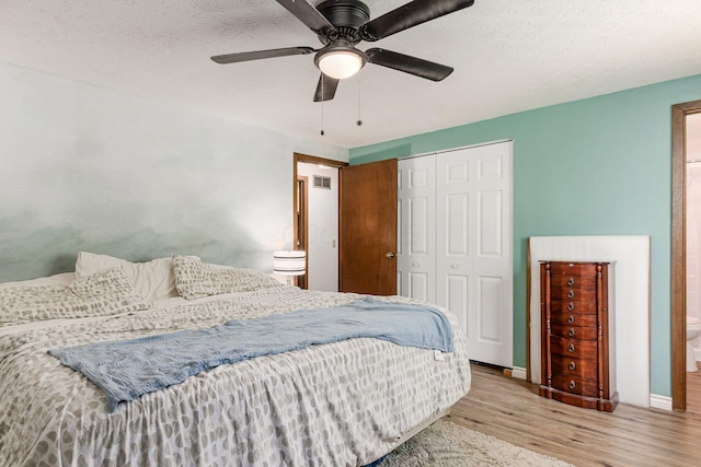 2630 Bella Via Ave, Columbus, OH 43231 - bedroom featuring wood finished floors, a closet, a ceiling fan, and a textured ceiling