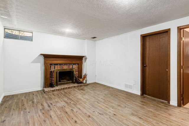 2630 Bella Via Ave, Columbus, OH 43231 - unfurnished living room with a textured ceiling, wood finished floors, and a fireplace