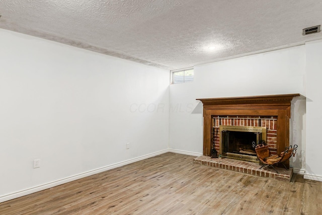 2630 Bella Via Ave, Columbus, OH 43231 - unfurnished living room featuring a textured ceiling, wood finished floors, and a fireplace