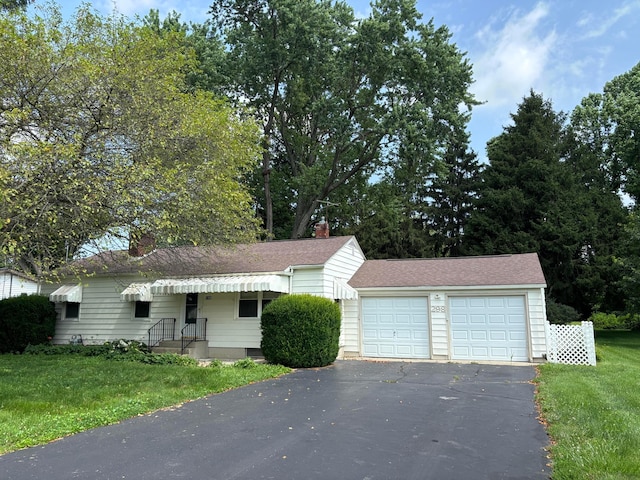 298 N Vernon Ave, Newark, OH 43055 - view of front facade featuring a chimney, driveway, an attached garage, and a front lawn