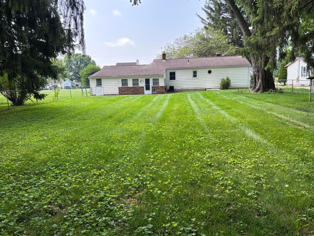 298 N Vernon Ave, Newark, OH 43055 - rear view of house featuring a fenced backyard and a chimney