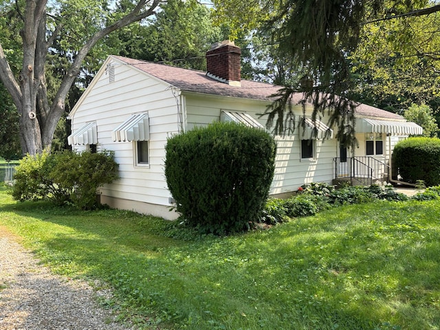 298 N Vernon Ave, Newark, OH 43055 - view of property exterior featuring a chimney, a lawn, and a shingled roof