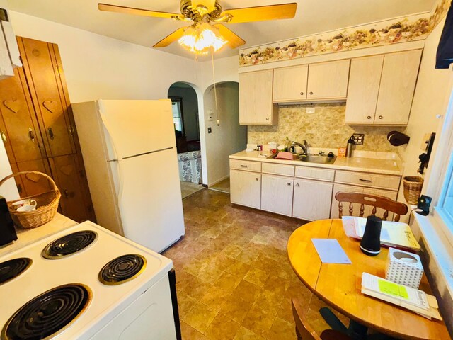 298 N Vernon Ave, Newark, OH 43055 - kitchen featuring white appliances, a ceiling fan, light countertops, tasteful backsplash, and arched walkways
