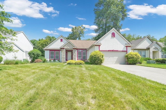 8078 Slate Ridge Blvd, Reynoldsburg, OH 43068 - view of front of home featuring an attached garage, stucco siding, a front lawn, driveway, and stone siding