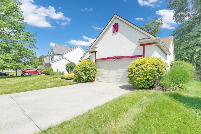 8078 Slate Ridge Blvd, Reynoldsburg, OH 43068 - view of front of property featuring concrete driveway, a front yard, a garage, and stucco siding