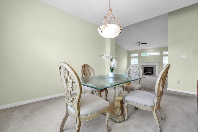 8078 Slate Ridge Blvd, Reynoldsburg, OH 43068 - dining space with carpet, a ceiling fan, a tiled fireplace, a chandelier, and lofted ceiling
