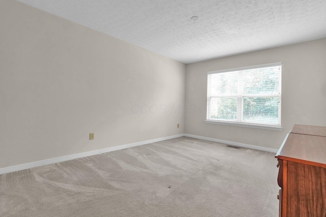 8078 Slate Ridge Blvd, Reynoldsburg, OH 43068 - spare room featuring light colored carpet and a textured ceiling
