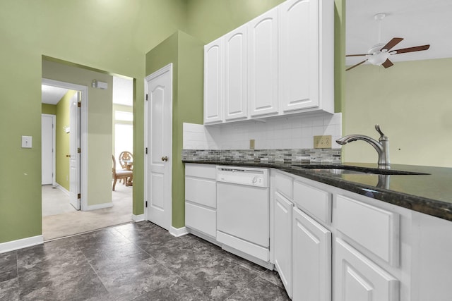 8078 Slate Ridge Blvd, Reynoldsburg, OH 43068 - kitchen featuring white dishwasher, a ceiling fan, white cabinetry, tasteful backsplash, and dark stone countertops