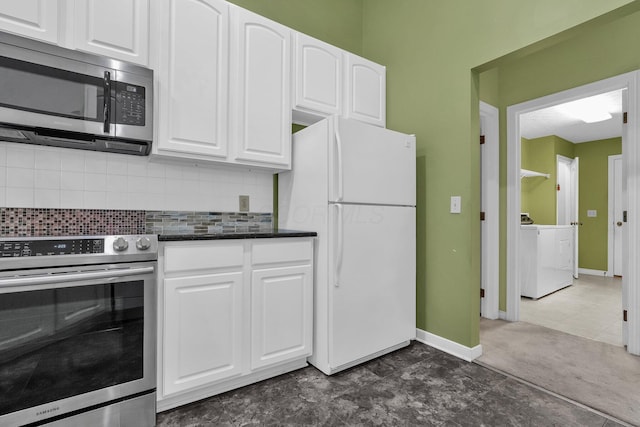 8078 Slate Ridge Blvd, Reynoldsburg, OH 43068 - kitchen featuring appliances with stainless steel finishes, washer / dryer, white cabinetry, backsplash, and dark stone countertops