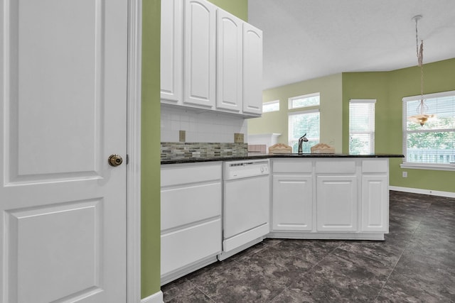 8078 Slate Ridge Blvd, Reynoldsburg, OH 43068 - kitchen featuring white dishwasher, white cabinets, healthy amount of natural light, and tasteful backsplash