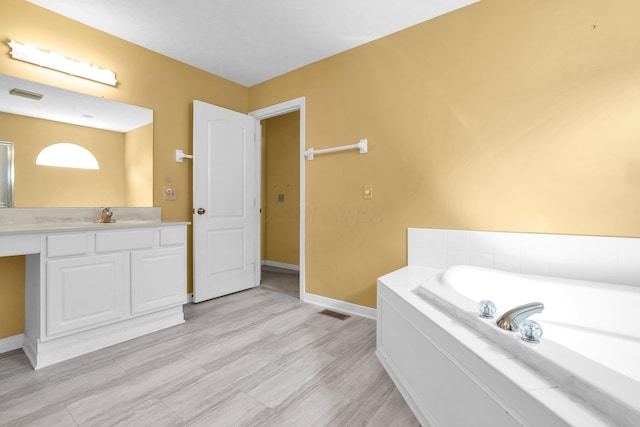 8078 Slate Ridge Blvd, Reynoldsburg, OH 43068 - bathroom with a garden tub and vanity