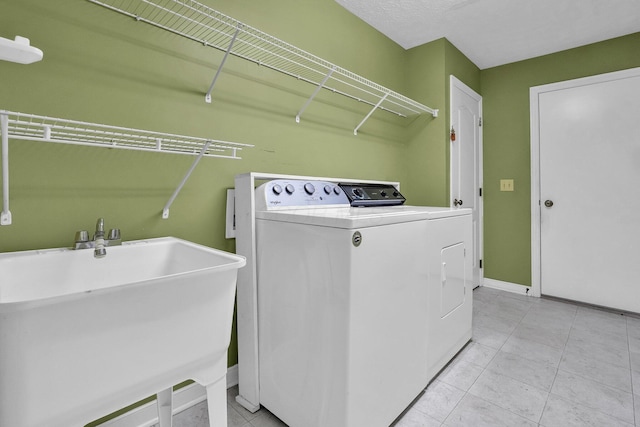 8078 Slate Ridge Blvd, Reynoldsburg, OH 43068 - laundry area featuring washer and dryer and light tile patterned floors