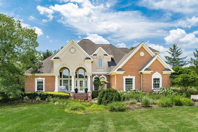 3873 Carters Corner Rd, Sunbury, OH 43074 - french country inspired facade with brick siding, a front yard, a shingled roof, and french doors