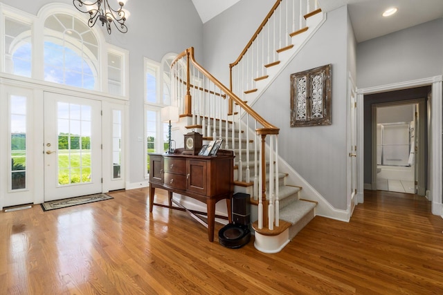 3873 Carters Corner Rd, Sunbury, OH 43074 - foyer featuring wood finished floors, a high ceiling, stairs, and a chandelier
