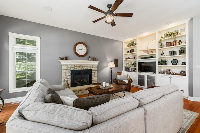 3873 Carters Corner Rd, Sunbury, OH 43074 - living area featuring a ceiling fan, wood finished floors, and a fireplace