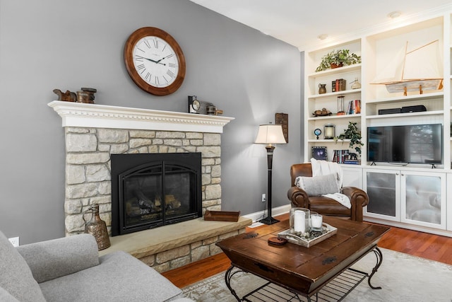 3873 Carters Corner Rd, Sunbury, OH 43074 - living room featuring wood finished floors, a fireplace, and built in features