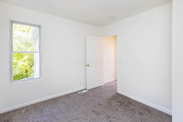 1718 S 3rd St, Columbus, OH 43207 - carpeted spare room with healthy amount of natural light and a smoke detector