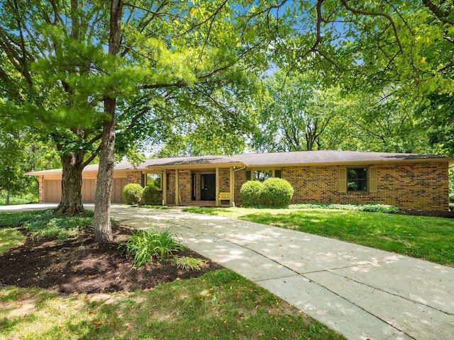 4656 Crompton Dr, Columbus, OH 43220 - view of front of property featuring concrete driveway, brick siding, a garage, and a front lawn