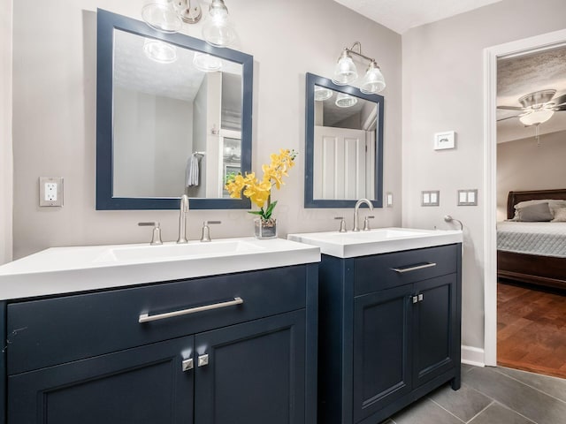 4656 Crompton Dr, Columbus, OH 43220 - ensuite bathroom with two vanities, a textured ceiling, tile patterned flooring, and a ceiling fan