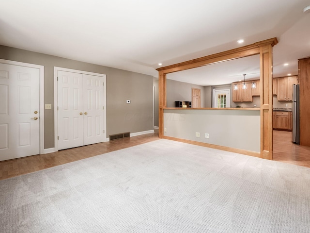 4656 Crompton Dr, Columbus, OH 43220 - unfurnished living room featuring recessed lighting, light colored carpet, and light wood-type flooring