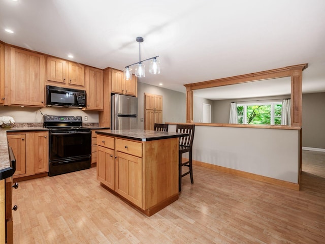 4656 Crompton Dr, Columbus, OH 43220 - kitchen featuring black appliances, light wood finished floors, dark countertops, and recessed lighting